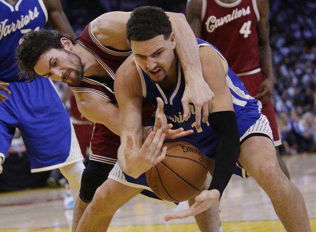 Golden State Warriors Klay Thompson front battles for a loose ball with Cleveland Cavaliers Kevin Love during the second half of an NBA basketball game F