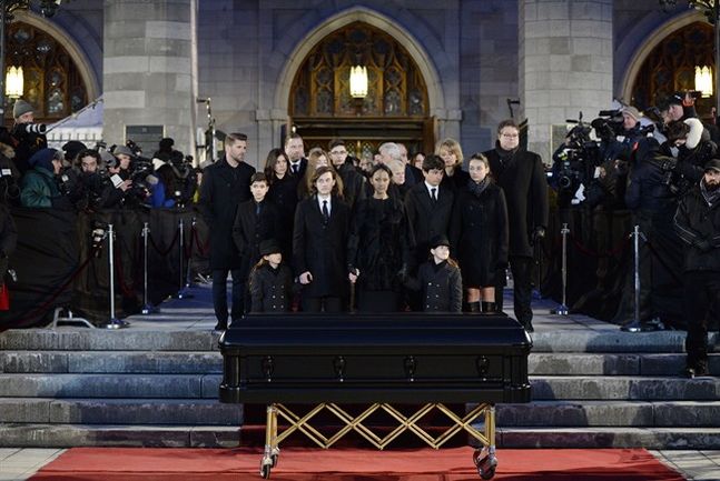 Celine Dion with sons Eddy and Nelson and Rene Charles Angelil stand before her late husband Rene Angelil's casket at Montreal's Notre Dame Basilica on Friday