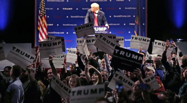 Trump fans show their support as a protester interrupts Thursday's rally