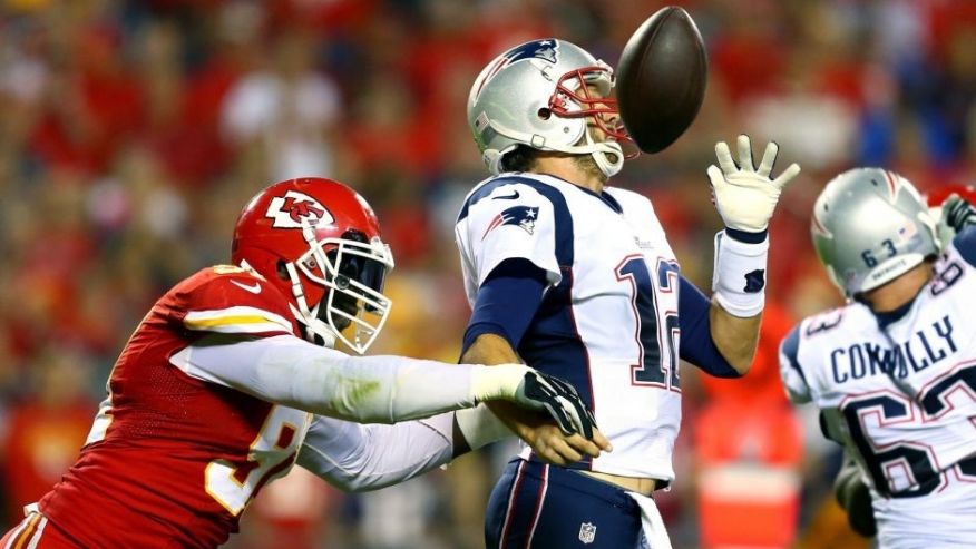 KANSAS CITY MO- SEPTEMBER 29 Tamba Hali #91 of the Kansas City Chiefs knocks the ball loose from Tom Brady #12 of the New England Patriots for a fumble during the third quarter at Arrowhead Stadium