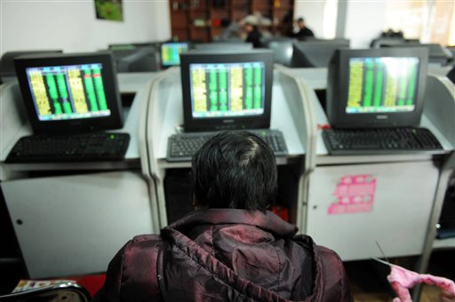 A Chinese stock investor sits in front of computer terminals at a brokerage house in Qingdao in eastern China's Shandong province Thursday Jan. 7 2016. China halted stock trading Thursday its second daylong trading suspension this week after pric