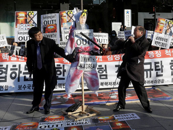 A South Korean protester with a wooden stick beats an effigy of North Korean leader Kim Jong Un during a rally against North Korea's announcement that it had tested a hydrogen bomb in Seoul South Korea Thursday Jan. 7 2016. The United States South K