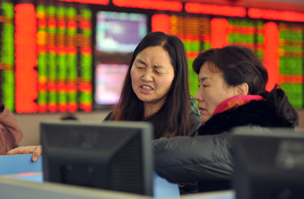 Two investors chat in a stock firm in Fuyang east China’s Anhui province. Trading on the Shanghai and Shenzhen stock exchanges was ended early on January 4 after shares fell seven per cent the first time China’s new ‘circuit breaker’ intervened