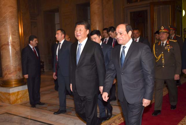 Egyptian President Abdel Fattah al Sisi walks with Chinese President Xi Jinping in Abdeen palace during the Chinese president's first day of his visit in Cairo Egypt