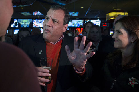 Chris Christie governor of New Jersey and 2016 Republican presidential candidate center talks to Steve Bookbinder left during a campaign stop with his wife Mary Pat Christie at Billy's Sports Bar in Manchester New Hampshire on Sunday Dec. 20 2015