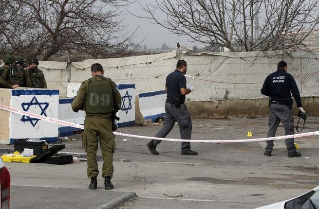 Israeli security forces inspect the scene where a Palestinian was shot dead after attempting to stab Israeli soldiers at the Beit Einun junction northeast of the West Bank city of Hebron