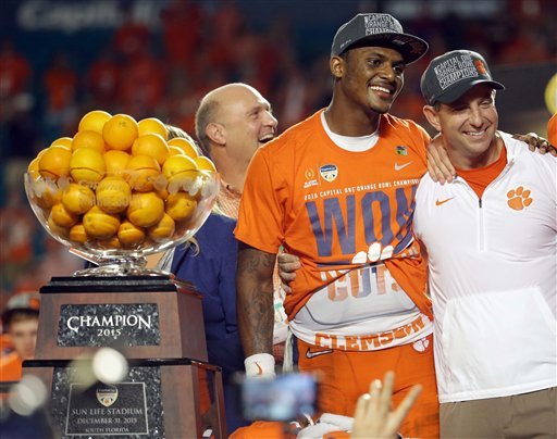 Clemson head coach Dabo Swinney poses with quarterback Deshaun Watson during Orange Bowl trophy presentation following the NCAA college football semifinal playoff game against Oklahoma Thursday Dec. 31 2015 in Miami Gardens Fla. Clemson defeated