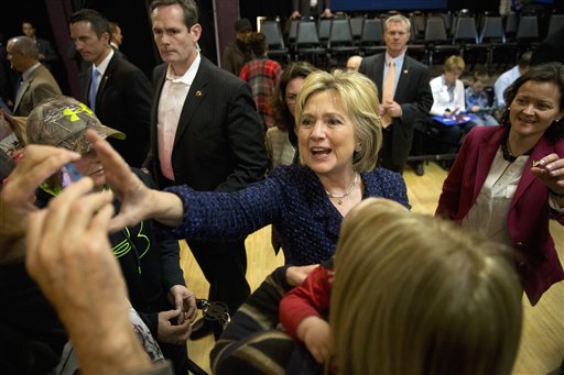 Democratic presidential candidate Hillary Clinton reaches for a smartphone for a selfie with a supporter after a campaign rally Monday