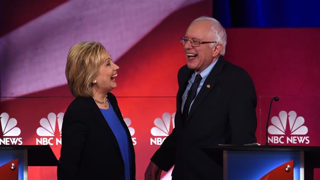 US Democratic presidential candidates Hillary Clinton and Bernie Sanders confer during the NBC News-YouTube Democratic Candidates Debate