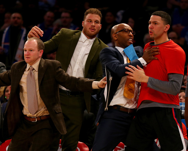 Austin Rivers #25 of the Los Angeles Clippers is held back by Sam Cassell and Blake Griffin as players from the New York Knicks and the Los Angeles Clippers exchange words on the court at Madison Square Garden