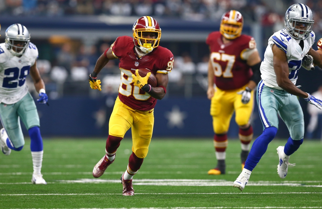 Jamison Crowder #80 of the Washington Redskins runs between Deji Olatoye #29 and Byron Jones #31 of the Dallas Cowboys during the first half at AT&T Stadium