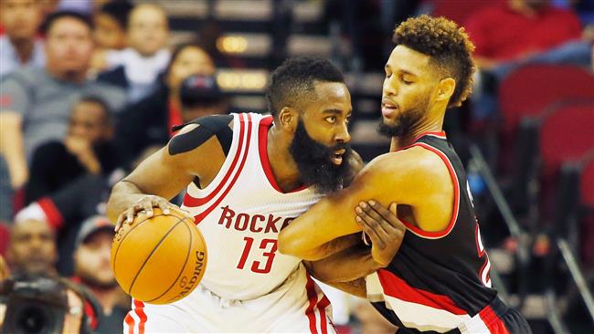 James Harden #13 of the Houston Rockets drives with the basketball against Allen Crabbe #23 of the Portland Trail Blazers during their game at the Toyota Center