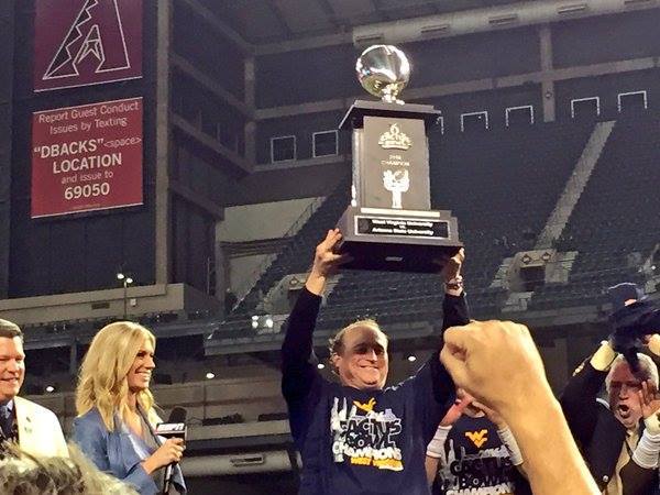 Dana Holgorsen lifting the Motel 6 Cactus Bowl trophy at Chase Field