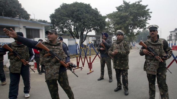 Security personnel stand guard inside the Indian air force base at Pathankot on Monday Jan. 4 2016. The country's defence minister said Tuesday the last of six gunmen who attacked the sprawling base over the weekend had been killed