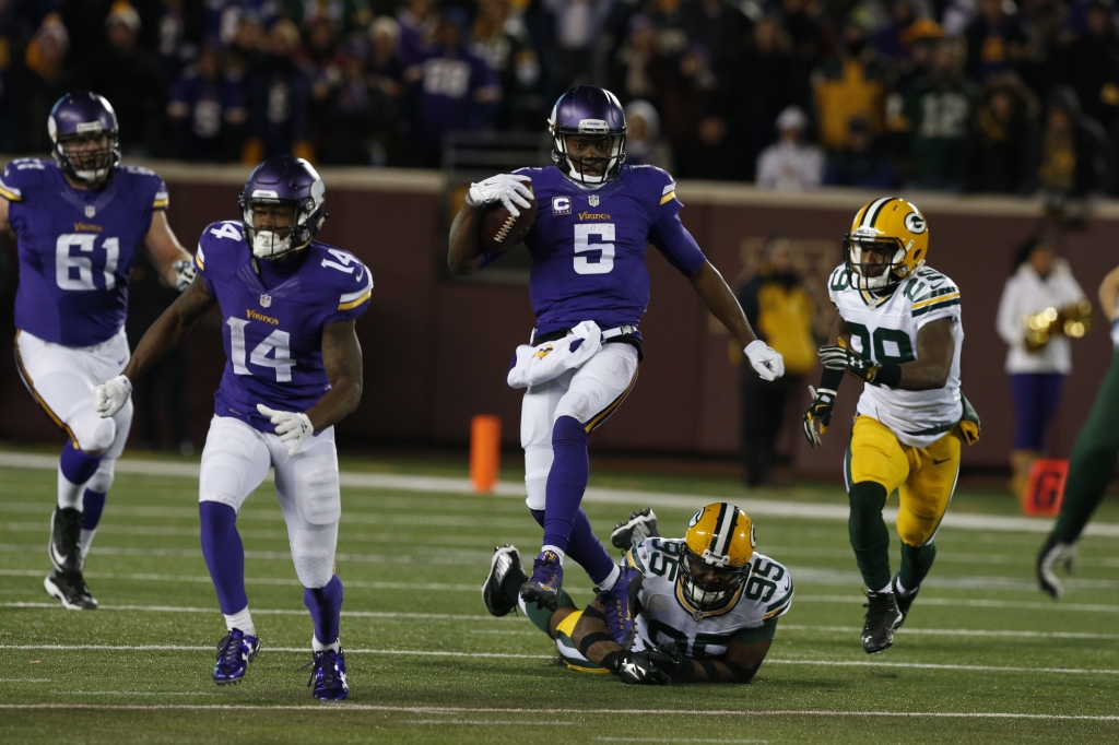 Minnesota Vikings quarterback Teddy Bridgewater evades Green Bay Packers defensive end Datone Jones during the second half of an NFL football game in Minneapolis Sunday Nov. 22 2015