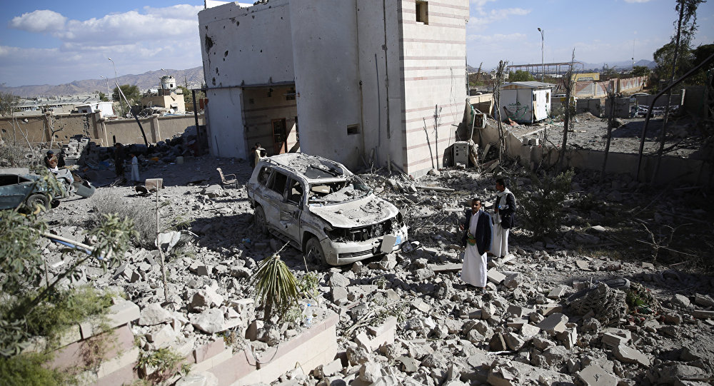 Men gather at the site of a house destroyed by Saudi-led airstrikes in Sanaa Yemen Friday Jan. 8 2016