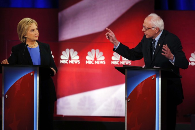 Democratic presidential candidate Sen. Bernie Sanders I-Vt gestures towards Democratic presidential candidate Hillary Clinton at the NBC You Tube Democratic presidential debate at the Gaillard Center Sunday Jan. 17 2016 in Charleston S.C. (AP Pho