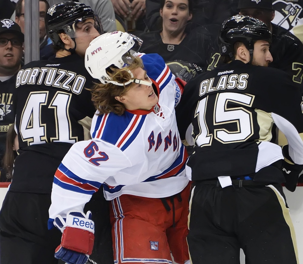 20140207pdPenguinsSports04-2 Rangers Carl Hagelin is sandwiched between Penguins Tanner Glass and Robert Birtuzzo at Consol Energy Center on Feb. 7 2014. Hagelin who signed with the Anaheim Ducks this offseason was traded to the Penguins on Saturday