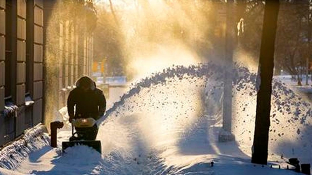 Snow is cleared along a street in the Upper West Side neighborhood of New York Sunday Jan. 24 2016 in the wake of a storm that dumped heavy snow along the East Coast