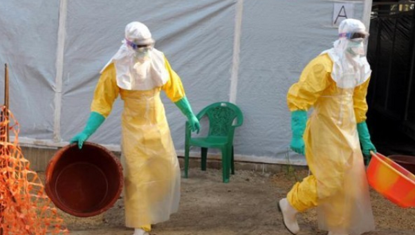 Doctors in protective gear work inside the medical humanitarian group Doctors without Borders isolation ward in the southern Guinean town of Gueckedou Mar.31 2014