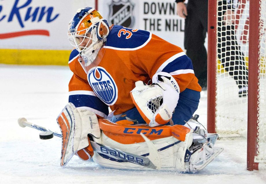 Edmonton Oilers goalie Cam Talbot makes a save against the Calgary Flames during the second period of an NHL hockey game in Edmonton Alberta Saturday Jan. 16 2016. MANDATORY CREDIT