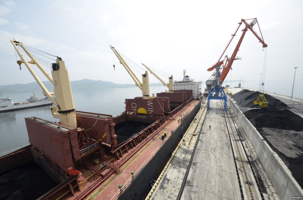 FILE- A cargo ship is loaded with coal during the opening ceremony of a new dock at the North Korean port of Rajin