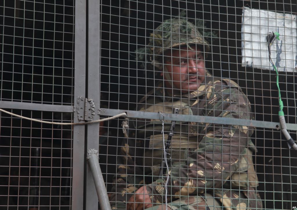 FILE- An Indian army soldier looks from inside an army vehicle at the Indian air force base in Pathankot India Jan. 4 2016