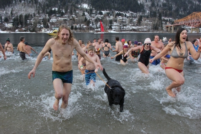 Faster than a speeding bullet particpants in the 2015 Polar Bear Dip rushed out of the waters of Kootenay Lake. — The Nelson Daily file