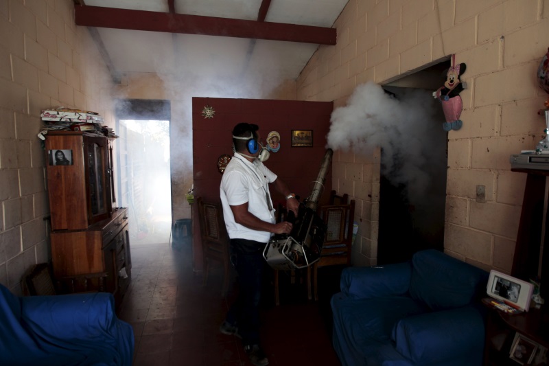 A health worker fumigates the Altos del Cerro neighbourhood as part of preventive measures against the Zika virus and other mosquito-borne diseases in Soyapango El Salvador