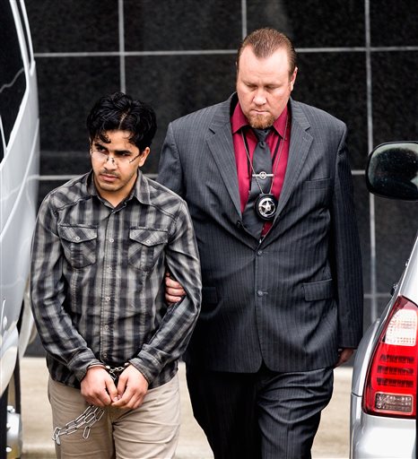 Omar Faraj Saeed Al Hardan left is escorted by U.S. Marshals from the Bob Casey Federal Courthouse in Houston. Al Hardan who came to Houston from Iraq in 2009 is set to be arraigned Wednesday Jan. 13 2015 and