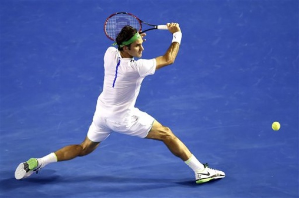 Roger Federer of Switzerland hits a backhand return to David Goffin of Belgium during their fourth round match at the Australian Open tennis championships in Melbourne Australia Sunday Jan. 24 2016. AP