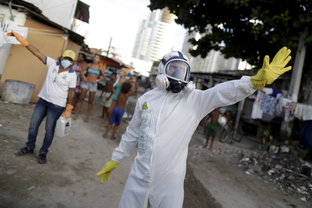 Municipal workers gesture before spraying insecticide at the neighborhood of Imbiribeira in Recife Brazil. Singapore is among countries who say they will take measures to control the risk of the mosquito-borne virus. – Reuters pic