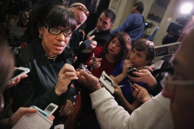 Flint Mayor Karen Weaver left talks to reporters Wednesday during the U.S. Conference of Mayors meeting in Washington