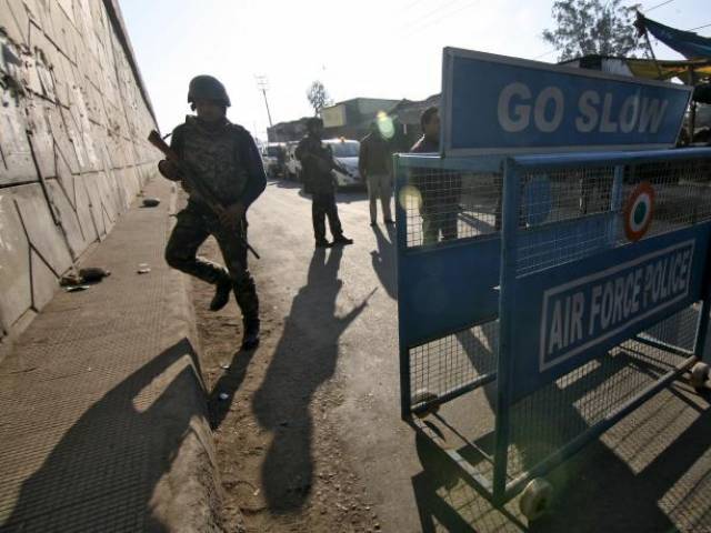 Indian security personnel stand guard next to a barricade outside the Indian Air Force base at Pathankot in Punjab India