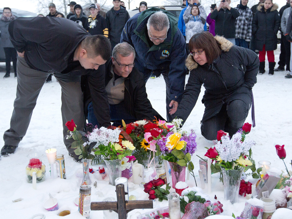 Left to right La Loche Mayor Kevin Janvier Saskatchewan Premier Brad Wall federal Public Safety Minister Ralph Goodale and MLA Georgina Jolibois lay flowers at a makeshift memorial at La Loche Sask.