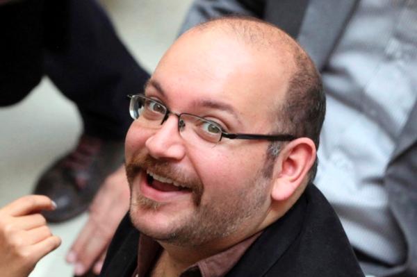 Jason Rezaian an Iranian American correspondent for the Washington Post smiles as he attends a presidential campaign of President Hassan Rouhani in Tehran Iran