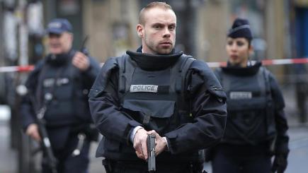 Armed police take up positions after an attempted attack on a police station in Paris