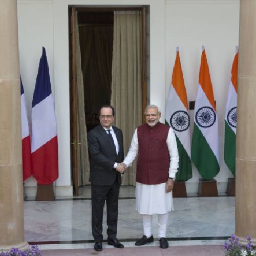 Francois Hollande left and Indian Prime Minister Narendra Modi shake hands as they pose before the start of a delegation level meeting in New Delhi India Monday Jan. 25 2016. Hollande began a three-day visit to India on Sund