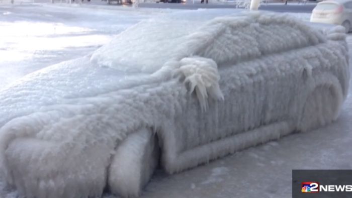 Freezing spray from Lake Erie's waves leave a parked car encased in ice