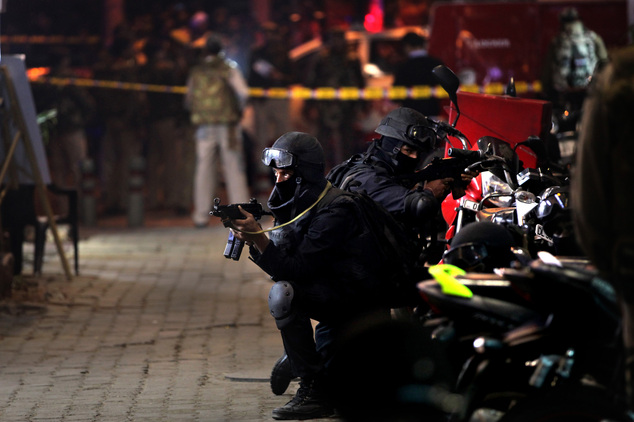 Commandos of National Security Group take positions during a mock terror attack drill ahead of Republic Day in New Delhi India Thursday Jan. 21 201