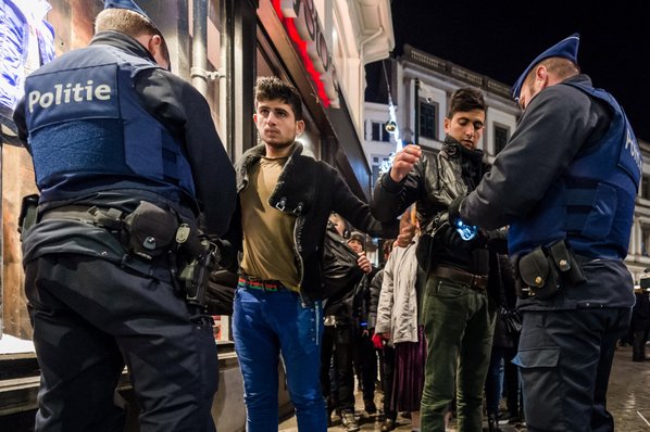 GEERT VANDEN WIJNGAERT						Credit AP				Police officers check people Thursday as they enter the Grand Place in Brussels