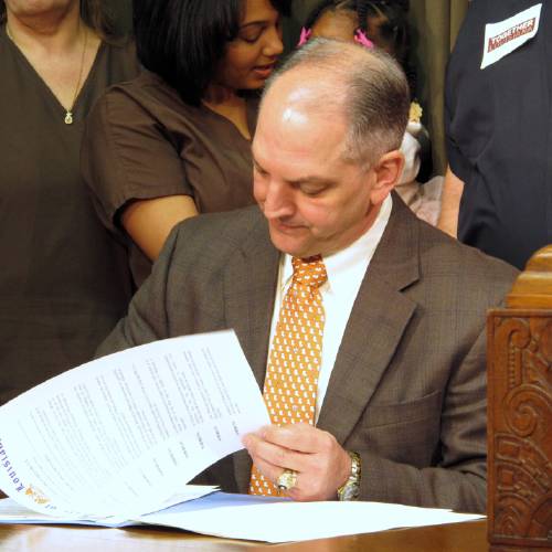 John Bel Edwards signs an executive order on his first full day in office starting the process for expanding Louisiana's Medicaid program as allowed under the federal health care law Tuesday Jan. 12 2016 in Baton Rouge La