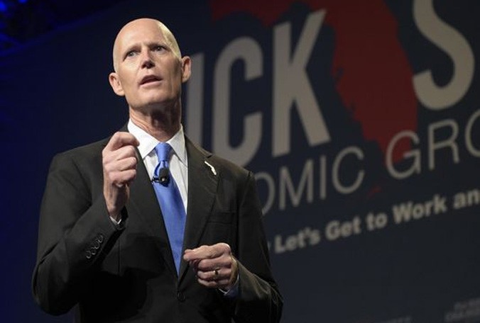 Florida Gov. Rick Scott gives the opening remarks during Rick Scott's Economic Growth Summit at Walt Disney World Tuesday