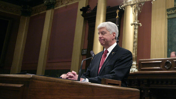 Michigan Gov. Rick Snyder left pauses as he delivers his State of the State address to a joint session of the House and Senate Tuesday Jan. 19 2016 at the state Capitol in Lansing Mich. Also seen are Lt Gov. Brian Calley and House Speaker Kevin Cot