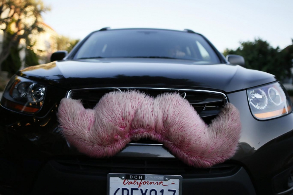 A driver with the ride-sharing service Lyft waits for a customer on a street in Santa Monica