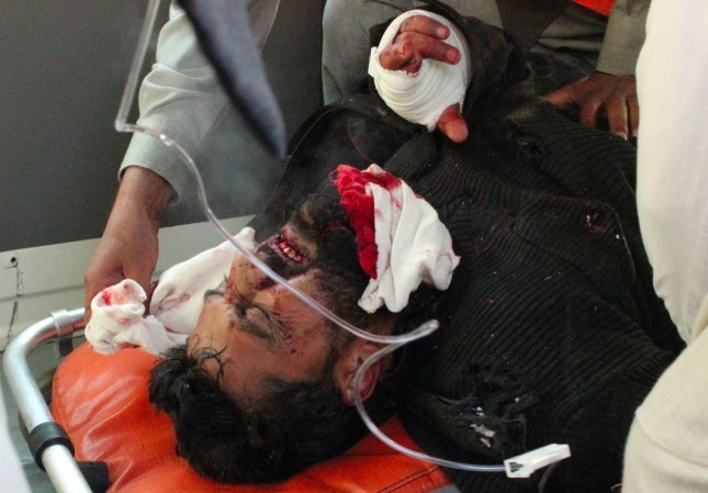 Pakistani volunteers rush an injured person to a local hospital after an attack on a university in Charsadda town some 21 miles outside the city of Peshawar Pakistan Wednesday Jan. 20 2016. Gunmen stormed Bacha Khan University named after the founder