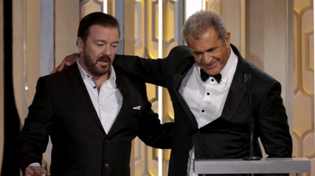 Host Ricky Gervais stands with presenter Mel Gibson at the 73rd Golden Globe Awards in Beverly Hills