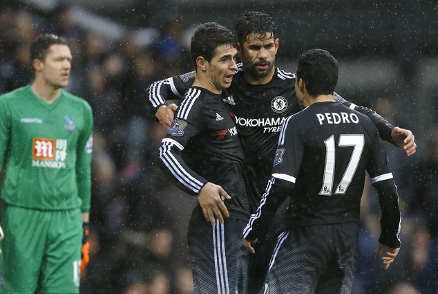 Chelsea's Oscar front left hugs Diego Costa centre and Pedro right as he celebrates scoring a goal during the English Premier League soccer match betw