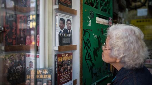 An elderly lady looks into a shop display of the Causeway Bay Books store in Hong Kong