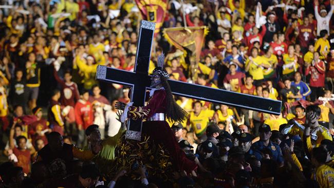 Devotees try to touch the life-sized Black Nazarene statue during the annual religious procession in honor of the Black Nazarene in Manila